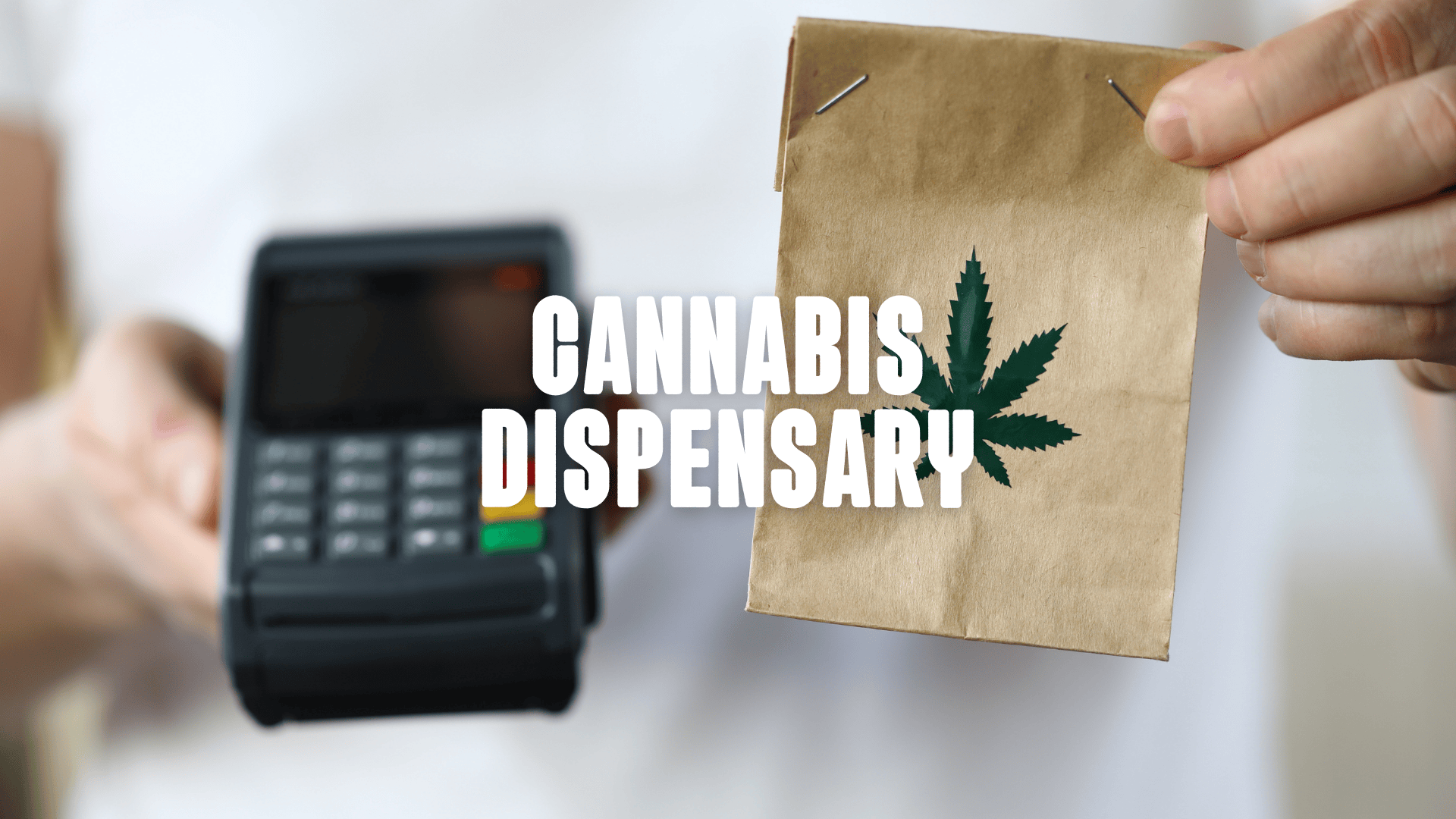 a paper bag with a weed leaf printed on it besides a debit card reading machine